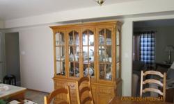 Solid oak dining room furniture includes double pedestal table, hutch and lighted buffet with 2 arm and 4 side chairs.  Table - 43 /12"w x 70"l and 2 leaves each 18"w
Hutch/Buffet 69"w x 19"deep x 80"h
All are in beautiful, as new condition.  Moving and