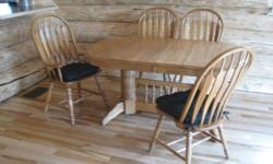 Solid Oak dining room table with 6 chairs, cushions included. Five feet in length, plus leaf. Excellent condition. Purchase price was $2500. Will sell for $899.