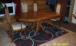 Solid wood construction. Table is 68" X 42" with the leaf installed. There are 4 matching chairs, 1 has arms.