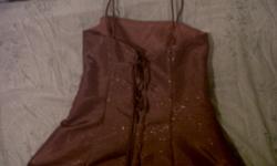 Size 13 sparkly hot pink prom dress, worn only once. Ties up in the back with a hot pink ribbon. Has spaghetti staps.