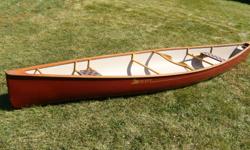 16' Swift Quetico Kevlar canoe. Top made of one piece black cherry from wilberforce ontario. Handcrafted by a builder in Algonquin park. Seats and rails made of ash . Front slider seat for leg length adjustment. Hand carved custom  neck yolk for