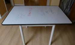 Table with a whiteboard top. 32" wide by 48" long. Excellent for crafts and games. Keep score or leave messages right on the table! Sits 4 people easily and 6 if you are friendly.