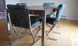Table and 4 chairs. Table has removable leaf. Good condition.