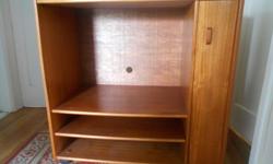 Teak unit -except top(faux -wood laminate) and back. Wheels, side cupboard set-up for VHS tapes,one pull-out shelf. Excellent condition. 36" w x 36"h x 19.5 deep. Inner cabinet space - 27"w x 20.5 " h.