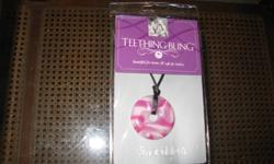 Brand new NEVER USED "Teething Bling" necklace. We got it for our baby but then he never had any problems with teething and doesn't like to chew on things a lot so I never used it. You can still wear jewelry and give your baby something to play with!