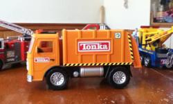 Great selection of tonka trucks, including couple not so easy to find now.
Garbage truck with sound, Power Supply truck with sound, really cool, folds down with crane for moving generators (?) around, Fire ladder truck with sound , Tow truck with sound,
