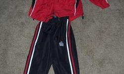 Red & Black (Signal Hill Soccer) child's coat and pants tracksuit made by Admiral. Zipper pockets, Velcro cuffs, string tie waistband, size small (approx age 7-10).