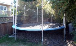 14' Diameter round trampoline with pads and safety net.