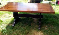 Large trestle table with two leafs. the table is solid wood with veneer. It has minor scratches on the surface. The base has been painted a deep chocolate brown & we were going to carefully strip the table top & stain it the same colour, However, my