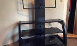 Black Glass TV stand - very sturdy (and heavy). Nice thick glass
Base is 44" wide, 24" tall. A 50" TV mounts on it easily.
Wide integrated mount hides cords etc.
Paid over $300 for it.