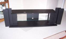 Black TV stand with glass shelf for up to a 62" TV. Stand is 661/2" long, 17" high, 13 1/2" deep. $100 OBRO. Good condition. Paid over $300.