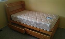 light wood twin size mates bed with 2 drawers. solid wood good shape .Has bookcase headboard. Mattress included with no stains or tears. Clean non smoker home $250 obo located at Big White Ski Resort but could deliver local to Kelowna