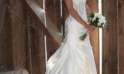 Beautiful corset wedding gown with tafetta skirt.
Very unique in sheer design bodice with embroidered flowers on it. Detail flows into the top of the skirting with lace up bodice.