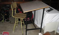This is a vintage drafting desk - I used one similar in shop class back in the early '80s and it would have already been dated then!  There are no markings that I can find to confirm age or manufacturer. However, this is a neat piece and would be great