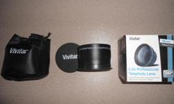 Vivitar 2.2x Professional Telephoto Converter that mounts on the front of camera lens, 58 mm thread. In the box, complete with both lens covers and soft pouch.