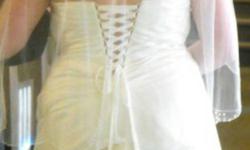 Hello,
 
I am looking to sell my wedding dress, veil and Tiara.
I was a healthy size 16 when I wore the dress, and the only taking in I had to do was just under the arms. It has the tie up in the back, so the dress could probably go up or down a size if