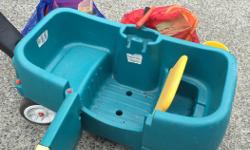 Here is a package deal. This wheel barrow is in perfect condition and great for the walk to the park or haul to the beach. Swinging door and storage under the seat.
Included with it is two big bags of sand toys, buckets, shovels, nettet bag.