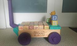 Winnie the Pooh trailer with wooden blocks. My kids loved walking around pulling this trailer with all sorts of things on it. Sadly they have grown out of it and it is looking for a new home.