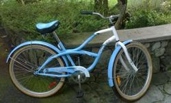 Blue and white women's classic cruiser in good condition. Includes fenders, an adjustable seat and 26 inch tires.