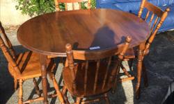 Beautiful wooden table and four chairs. Quality built in Quebec Canada. Table has removable leaf and a few minor scratches. The chairs are in excellent condition.