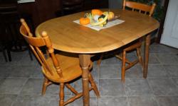 Wooden kitchen table and 2 chairs for sale.  In great shape,with some wear due to age.  Solid table and chairs.
