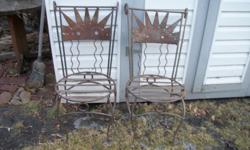 Two heavy wrought iron patio chairs. Will sell individually for $35 each.