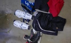 Almost a full set of hockey gear. Includes:
RBK Shin Pads (13" / 33cm)
Nike/Bauer Pants (Jr. Large)(26-28")
CCM RBZ 70 skates (size 6.5 US) - well used
Jofa Shoulder pads Jr. Size 3 (L/XL) (not in photo)
2 Practice Jerseys (Red & Blue)
1 Pair of hockey